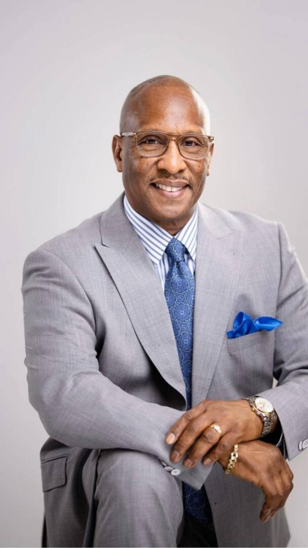 Smiling professional in gray suit, blue tie